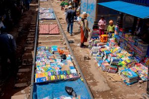 Peru train crossing through a open air market