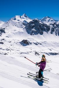 Val d'Anniviers skiers with a view to the Swiss Alps and Weisshorn